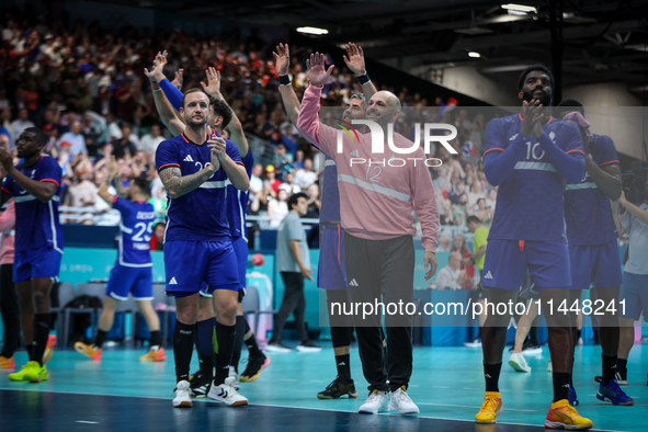 The France team is celebrating after the men's Handball Preliminary Round - Group B match between France and Egypt in Paris, France, on July...