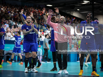 The France team is celebrating after the men's Handball Preliminary Round - Group B match between France and Egypt in Paris, France, on July...