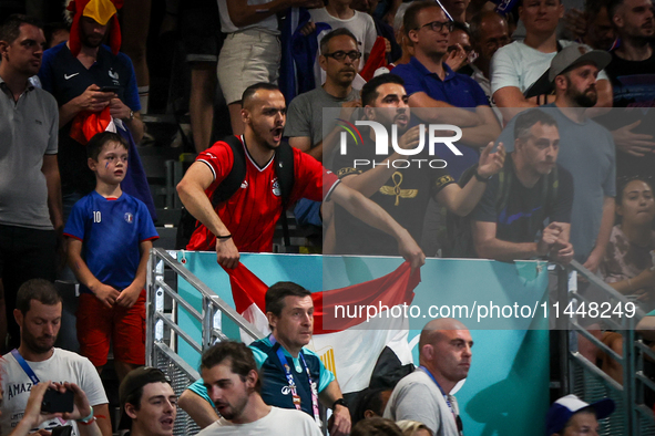 A fan of the Egypt team is cheering during the men's Handball Preliminary Round - Group B match between France and Egypt on Day 5 of the Oly...