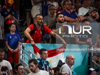 A fan of the Egypt team is cheering during the men's Handball Preliminary Round - Group B match between France and Egypt on Day 5 of the Oly...