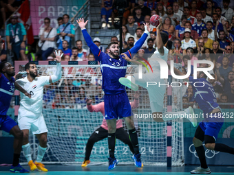 Yahia OMAR of the Egypt team is shooting at the goal against Ludovic FABREGAS of the France team during the men's Handball Preliminary Round...