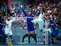 Yahia OMAR of the Egypt team is shooting at the goal against Ludovic FABREGAS of the France team during the men's Handball Preliminary Round...