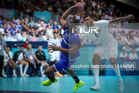 Dylan NAHI of the France team is shooting at the goal against Yahia OMAR of the Egypt team during the men's Handball Preliminary Round - Gro...