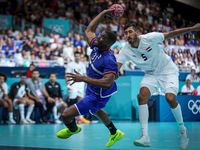 Dylan NAHI of the France team is shooting at the goal against Yahia OMAR of the Egypt team during the men's Handball Preliminary Round - Gro...