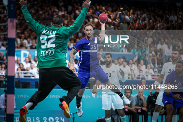 Valentin PORTE of the France team is shooting at the goal against Mohamed ALY, the goalkeeper of the Egypt team, during the men's Handball P...