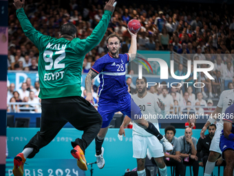 Valentin PORTE of the France team is shooting at the goal against Mohamed ALY, the goalkeeper of the Egypt team, during the men's Handball P...