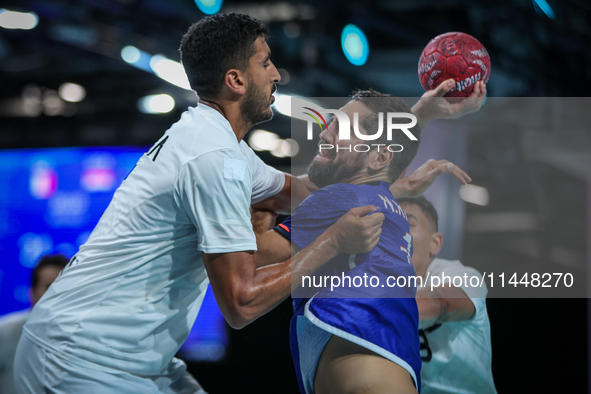 Yahia OMAR of the Egypt team is battling for the ball with Nedim REMILI of the France team during the men's Handball Preliminary Round - Gro...