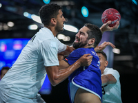 Yahia OMAR of the Egypt team is battling for the ball with Nedim REMILI of the France team during the men's Handball Preliminary Round - Gro...