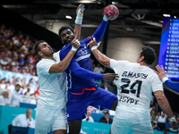 Dika MEM of the France team is shooting at the goal against Abdelrahman ABDOU and Ibrahim ELMASRY of the Egypt team during the men's Handbal...