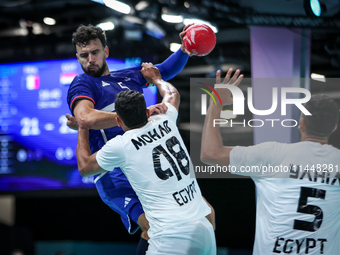 Nedim Remili of the France team is shooting at the goal against Mohab Abdelhak of the Egypt team during the men's Handball Preliminary Round...