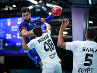 Nedim Remili of the France team is shooting at the goal against Mohab Abdelhak of the Egypt team during the men's Handball Preliminary Round...