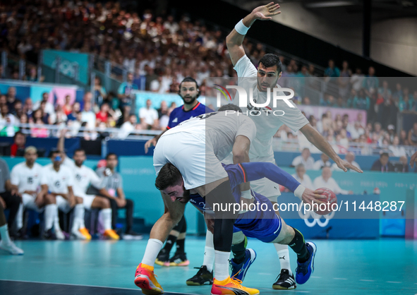 Luka Karabatic of the France team is shooting at the goal against Ibrahim Elmasry of the Egypt team during the men's Handball Preliminary Ro...