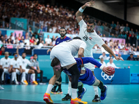 Luka Karabatic of the France team is shooting at the goal against Ibrahim Elmasry of the Egypt team during the men's Handball Preliminary Ro...