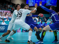 Nedim REMILI of the France team is shooting at the goal against Ali ZEIN and Yehia ELDERAA of the Egypt team during the men's Handball Preli...