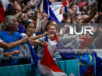 Fans of the France team are cheering during the men's Handball Preliminary Round - Group B match between France and Egypt on Day 5 of the Ol...