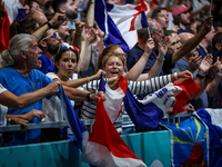 Fans of the France team are cheering during the men's Handball Preliminary Round - Group B match between France and Egypt on Day 5 of the Ol...