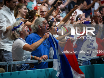 Fans of the France team are cheering during the men's Handball Preliminary Round - Group B match between France and Egypt on Day 5 of the Ol...