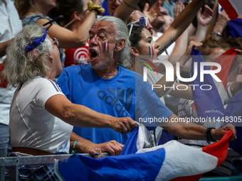 Fans of the France team are cheering during the men's Handball Preliminary Round - Group B match between France and Egypt on Day 5 of the Ol...