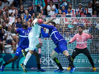 Yehia ELDERAA of the Egypt team is shooting at the goal against Karl KONAN and Ludovic FABREGAS of the France team during the men's Handball...