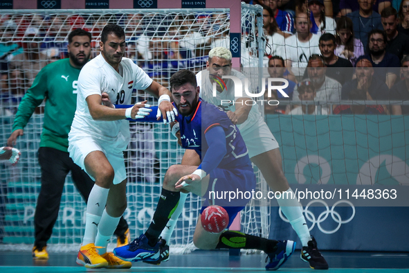 Ludovic FABREGAS of the France team is shooting at the goal against Ahmed HESHAM and Abdelrahman ABDOU of the Egypt team during the men's Ha...