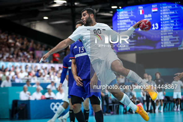 Ahmed ADEL of the Egypt team is shooting the ball during the Men's Preliminary Round Group B match between France and Egypt in Paris, France...