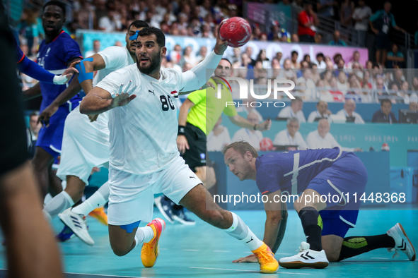 Ahmed ADEL of the Egypt team is shooting the ball during the Men's Preliminary Round Group B match between France and Egypt in Paris, France...