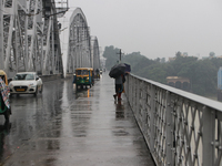 Commuters are crossing Vivekananda Bridge over the River Ganga during monsoon rain in Kolkata, India, on August 1, 2024. (