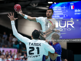 Yehia ELDERAA is passing to Mohamed TAREK of the Egypt team during the men's Handball Preliminary Round - Group B match between France and E...