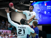 Yehia ELDERAA is passing to Mohamed TAREK of the Egypt team during the men's Handball Preliminary Round - Group B match between France and E...