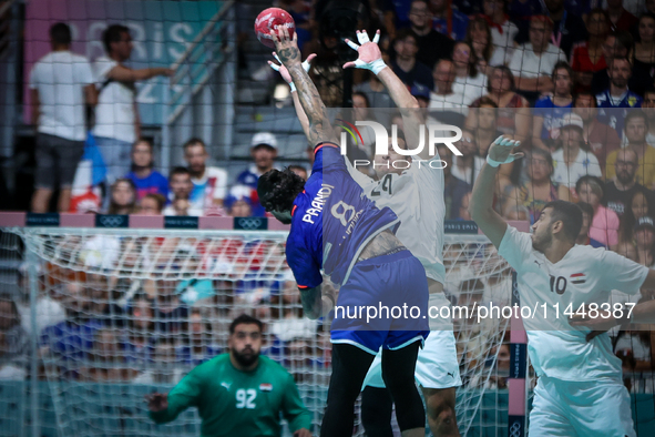 Elohim PRANDI of the France team is shooting at the goal against Ibrahim ELMASRY of the Egypt team during the men's Handball Preliminary Rou...