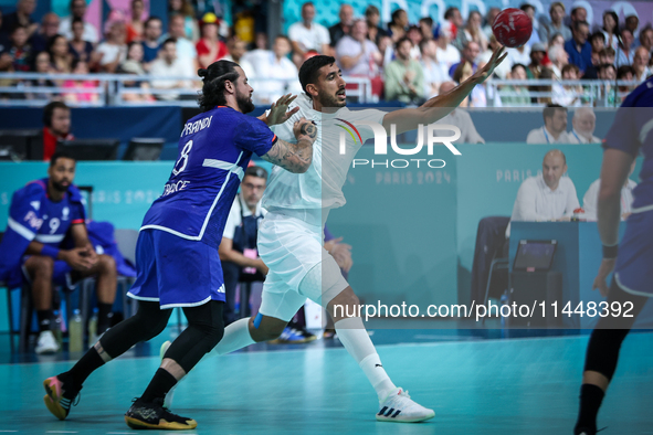 Yahia OMAR of the Egypt team is battling for the ball with Elohim PRANDI of the France team during the men's Handball Preliminary Round - Gr...