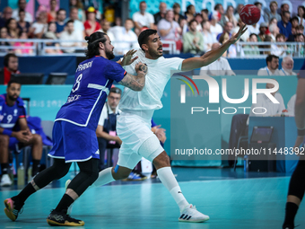 Yahia OMAR of the Egypt team is battling for the ball with Elohim PRANDI of the France team during the men's Handball Preliminary Round - Gr...