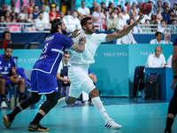 Yahia OMAR of the Egypt team is battling for the ball with Elohim PRANDI of the France team during the men's Handball Preliminary Round - Gr...