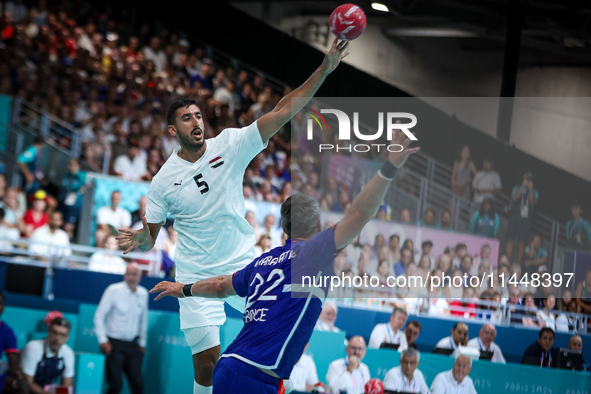 Yahia OMAR of the Egypt team is shooting at the goal against Luka KARABATIC of the France team during the men's Handball Preliminary Round -...