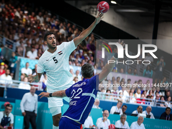 Yahia OMAR of the Egypt team is shooting at the goal against Luka KARABATIC of the France team during the men's Handball Preliminary Round -...