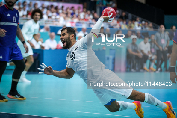 Ahmed ADEL of the Egypt team is shooting the ball during the Men's Preliminary Round Group B match between France and Egypt in Paris, France...