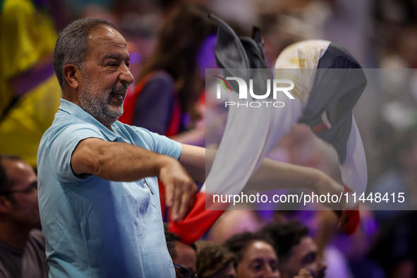 A fan of the Egypt team is cheering before the Men's Preliminary Round Group B match between France and Egypt on day five of the Olympic Gam...