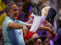 A fan of the Egypt team is cheering before the Men's Preliminary Round Group B match between France and Egypt on day five of the Olympic Gam...