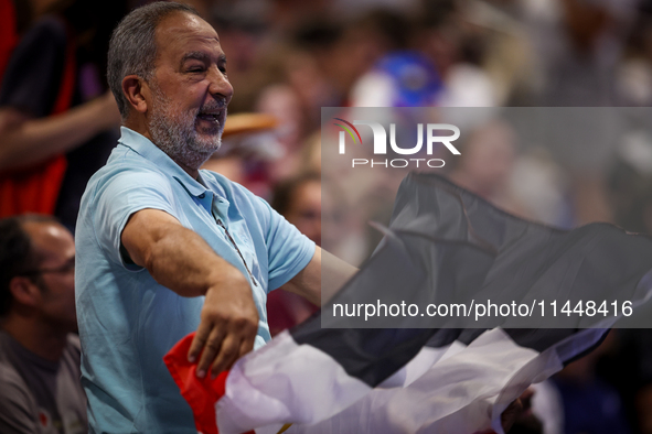 A fan of the Egypt team is cheering before the Men's Preliminary Round Group B match between France and Egypt on day five of the Olympic Gam...