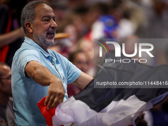 A fan of the Egypt team is cheering before the Men's Preliminary Round Group B match between France and Egypt on day five of the Olympic Gam...