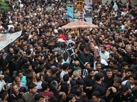 Kashmiri Shiite Muslims are reenacting the scene by touching the horse during a religious procession in Srinagar, Jammu and Kashmir, on Augu...