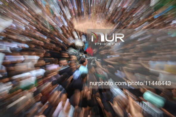 In this picture taken with a zoom burst, Kashmiri Shiite Muslims are reenacting the scene by touching the horse during a religious processio...