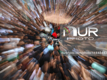 In this picture taken with a zoom burst, Kashmiri Shiite Muslims are reenacting the scene by touching the horse during a religious processio...