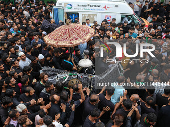 Kashmiri Shiite Muslims are reenacting the scene by touching the horse during a religious procession in Srinagar, Jammu and Kashmir, on Augu...