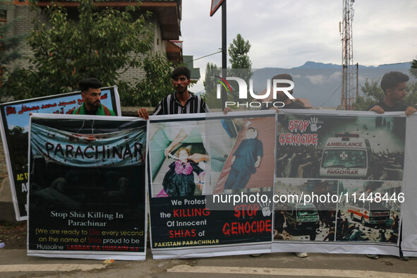 Kashmiri Shiite Muslims are holding banners during a religious procession on the 25th day of the Islamic month of Muharram in Srinagar, Jamm...