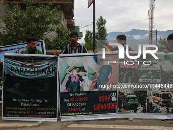 Kashmiri Shiite Muslims are holding banners during a religious procession on the 25th day of the Islamic month of Muharram in Srinagar, Jamm...