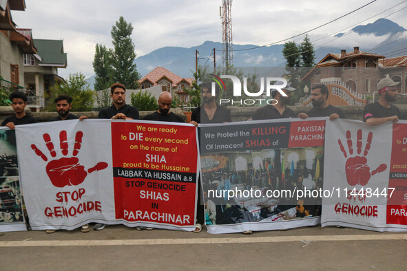 Kashmiri Shiite Muslims are holding banners during a religious procession on the 25th day of the Islamic month of Muharram in Srinagar, Jamm...