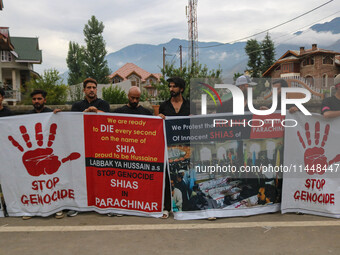 Kashmiri Shiite Muslims are holding banners during a religious procession on the 25th day of the Islamic month of Muharram in Srinagar, Jamm...