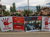 Kashmiri Shiite Muslims are holding banners during a religious procession on the 25th day of the Islamic month of Muharram in Srinagar, Jamm...