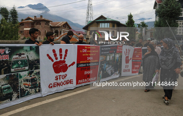 A woman is walking past Kashmiri Shiite Muslims holding banners during a religious procession on the 25th day of the Islamic month of Muharr...